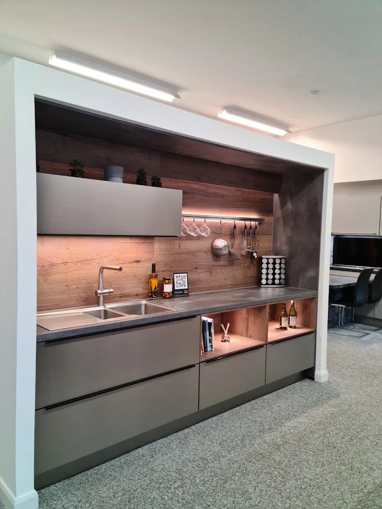 Inside The Kitchen Station showroom with kitchen display bays and a design desk